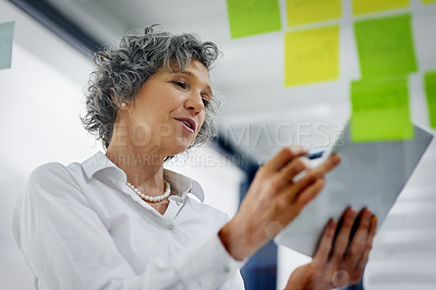 Buy stock photo Glass wall, tablet and business woman planning, strategy and research in workplace. Sticky notes, brainstorming and senior female professional with technology for working, schedule and low angle.