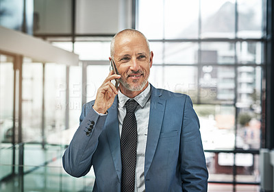 Buy stock photo Portrait of a mature businessman talking on a cellphone in a modern office