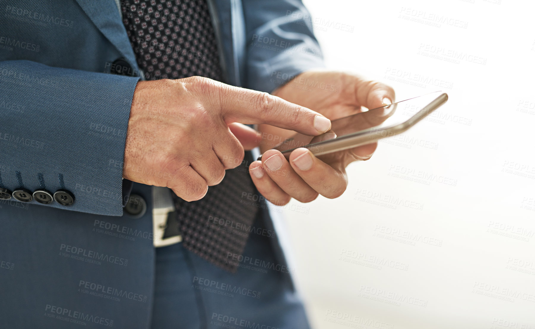 Buy stock photo Closeup shot of a businessman texting on a cellphone