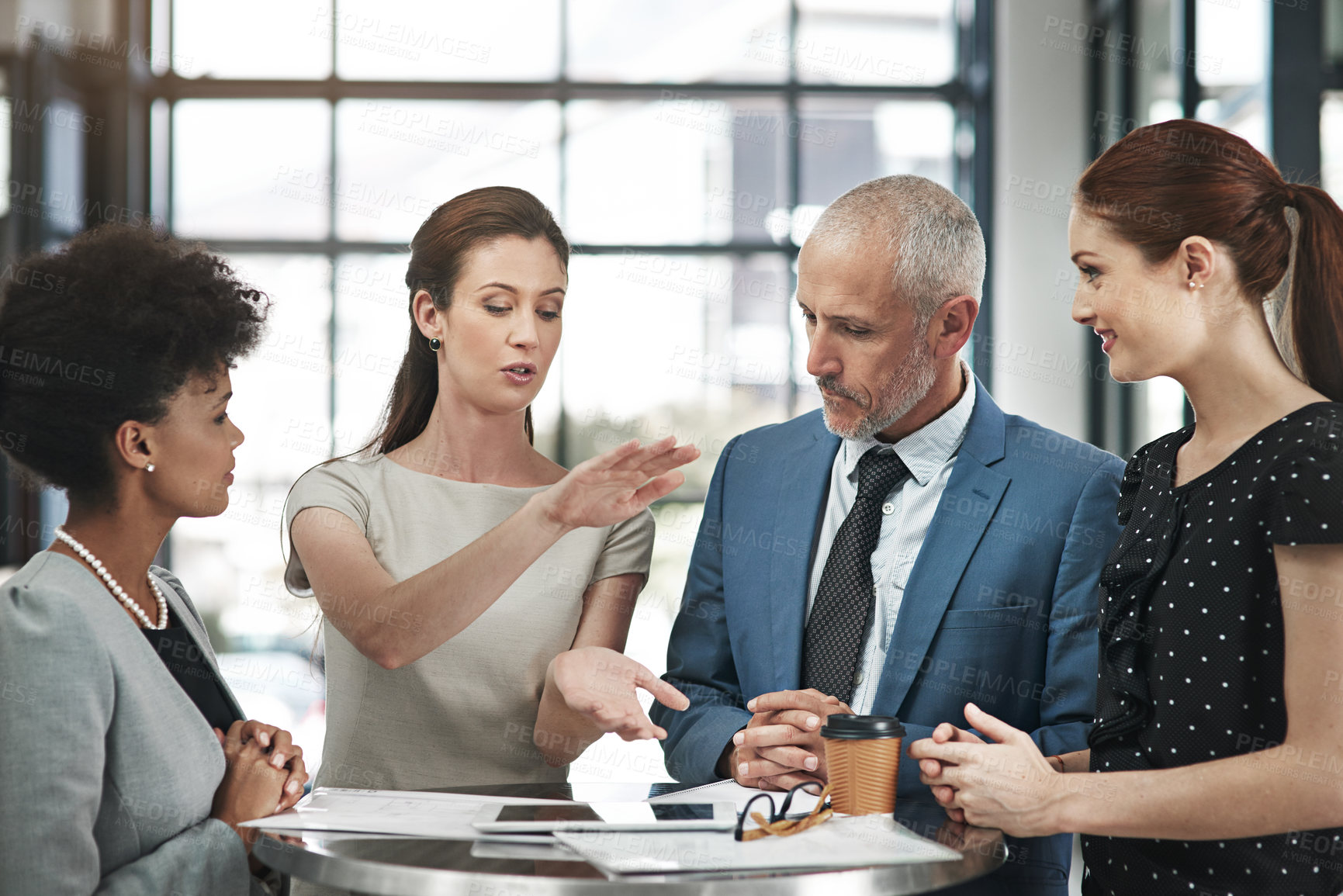 Buy stock photo Cropped shot of a group of businesspeople having a meeting in a modern office