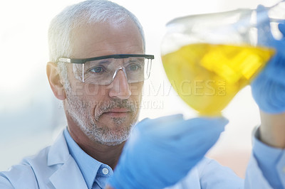 Buy stock photo Cropped shot of a male scientist conducting an experiment in a lab