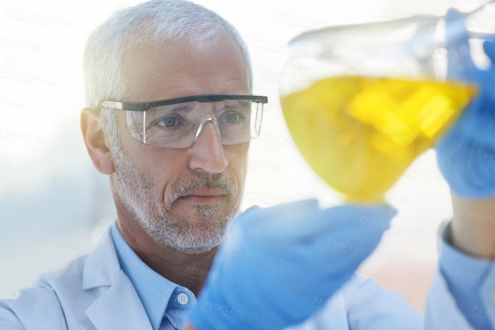 Buy stock photo Cropped shot of a male scientist conducting an experiment in a lab