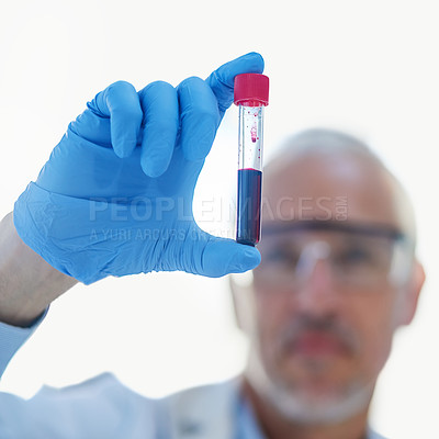 Buy stock photo Closeup shot of a male scientist examining a test tube in a lab