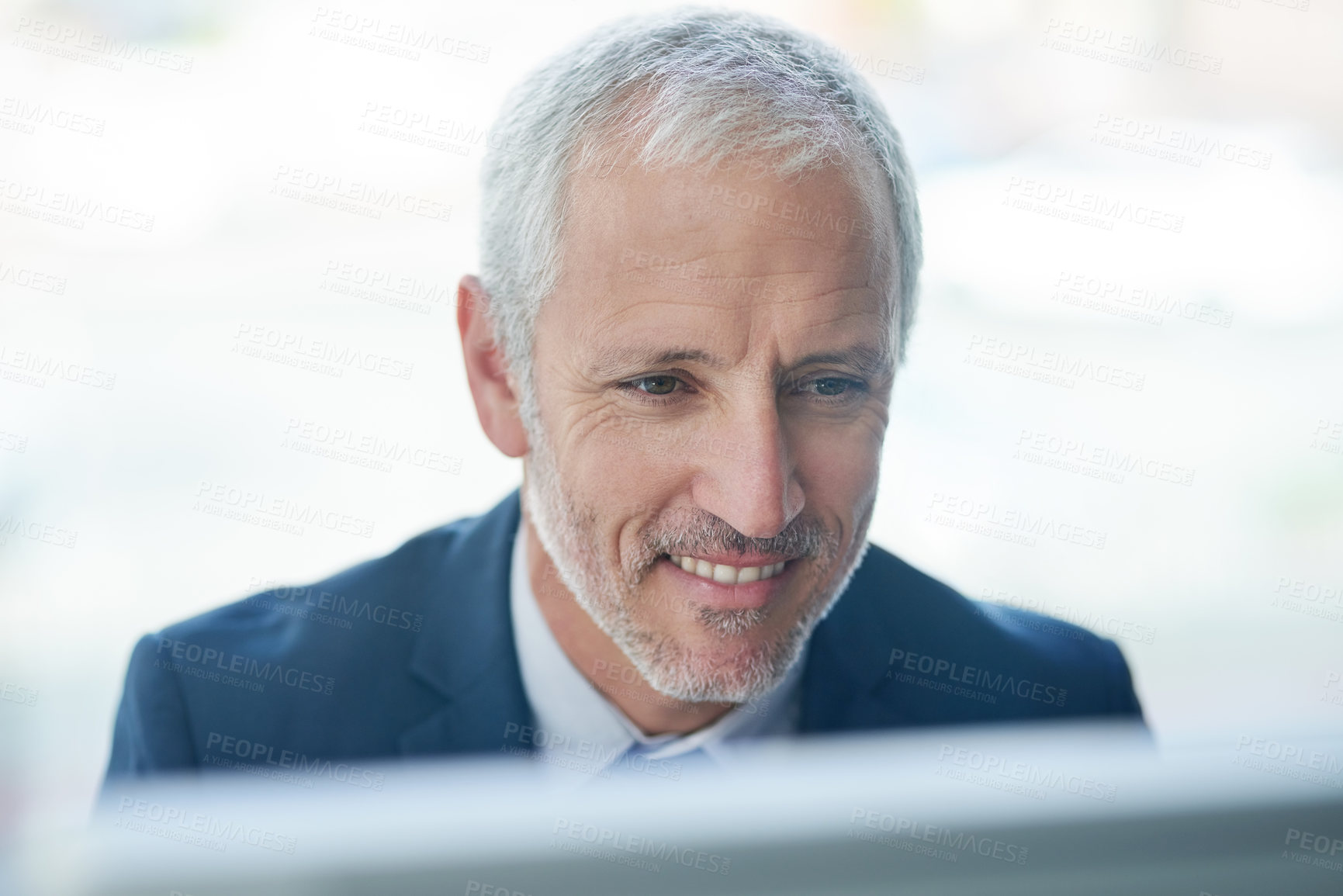 Buy stock photo Cropped shot of a mature businessman working on a computer in a modern office