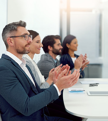 Buy stock photo Cropped shot of a group of businesspeople clapping their hands together in a modern office