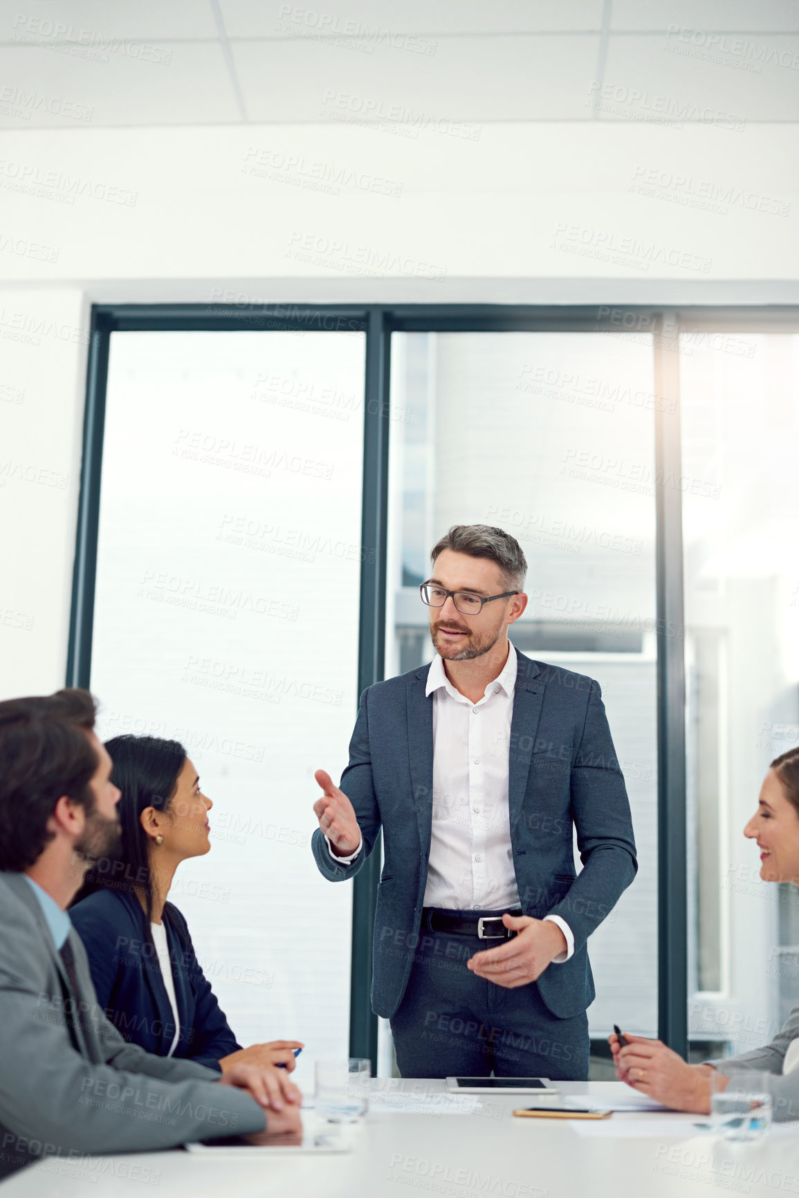 Buy stock photo Cropped shot of a businessman giving a presentation to his colleagues in a modern office