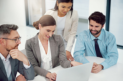 Buy stock photo Cropped shot of a group of businesspeople working together in a laptop in a modern office