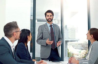 Buy stock photo Cropped shot of a businessman giving a presentation to his colleagues in a modern office