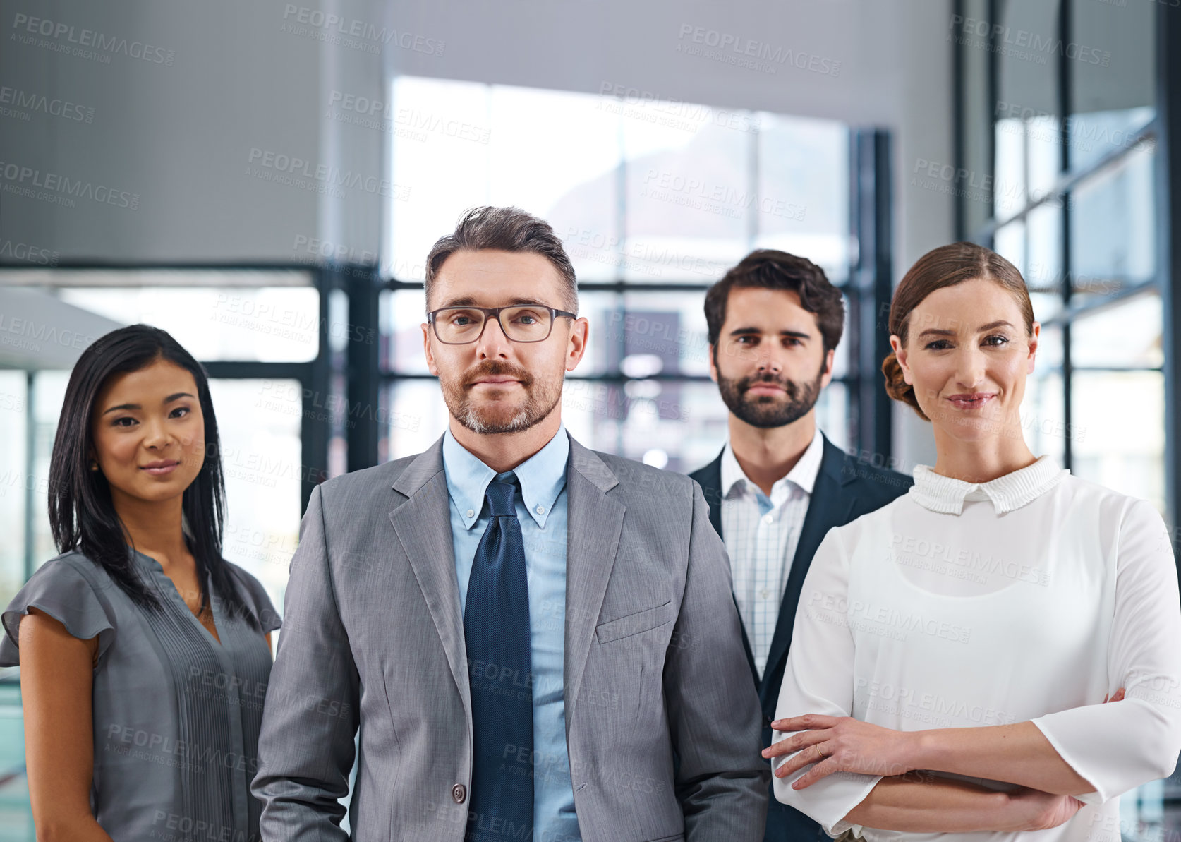 Buy stock photo Cropped portrait of a group of businesspeople standing in the office