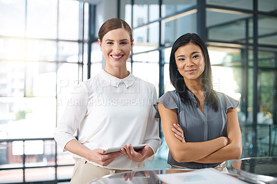 Buy stock photo Cropped portrait of two businesswomen standing in the office