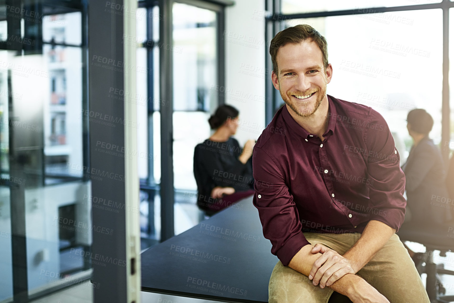 Buy stock photo Portrait of a businessman in a boardroom with his colleagues blurred out in the background