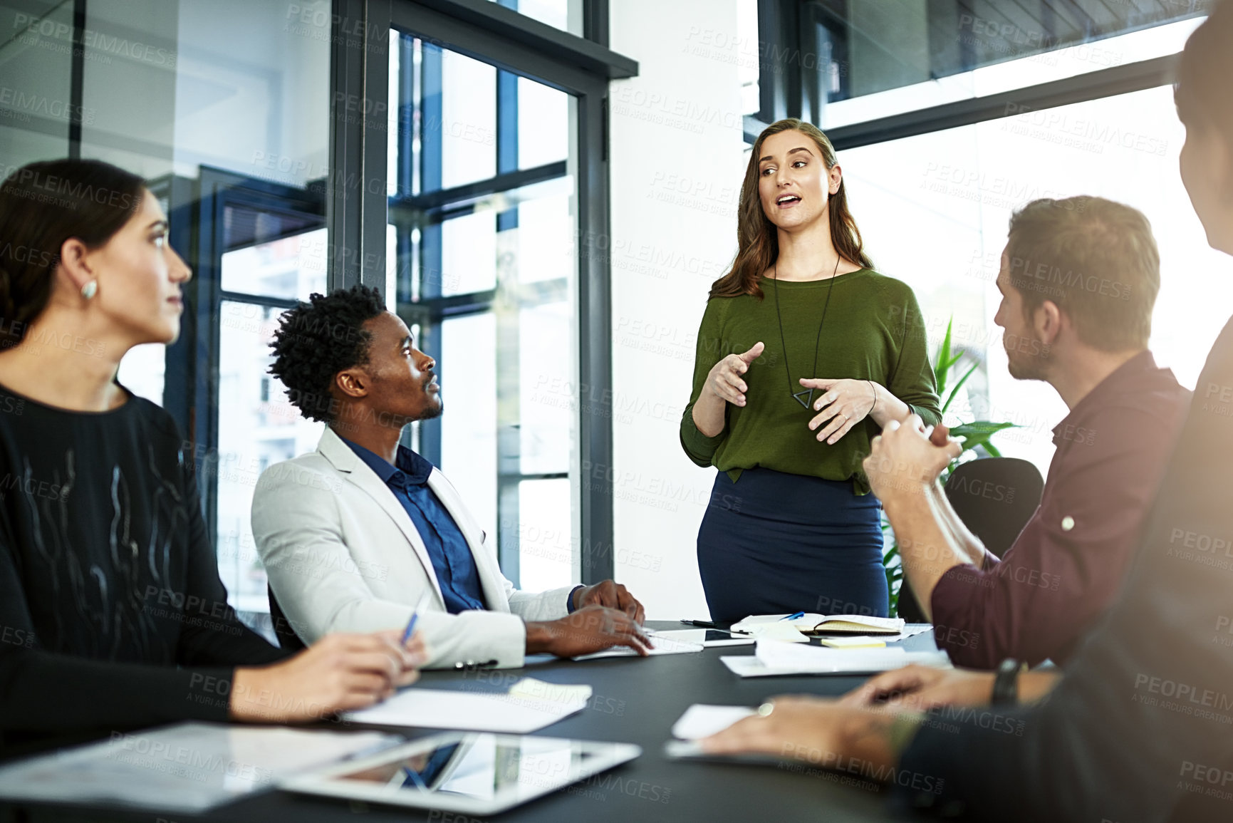 Buy stock photo Shot of a businesswoman delivering a presentation to her coworkers