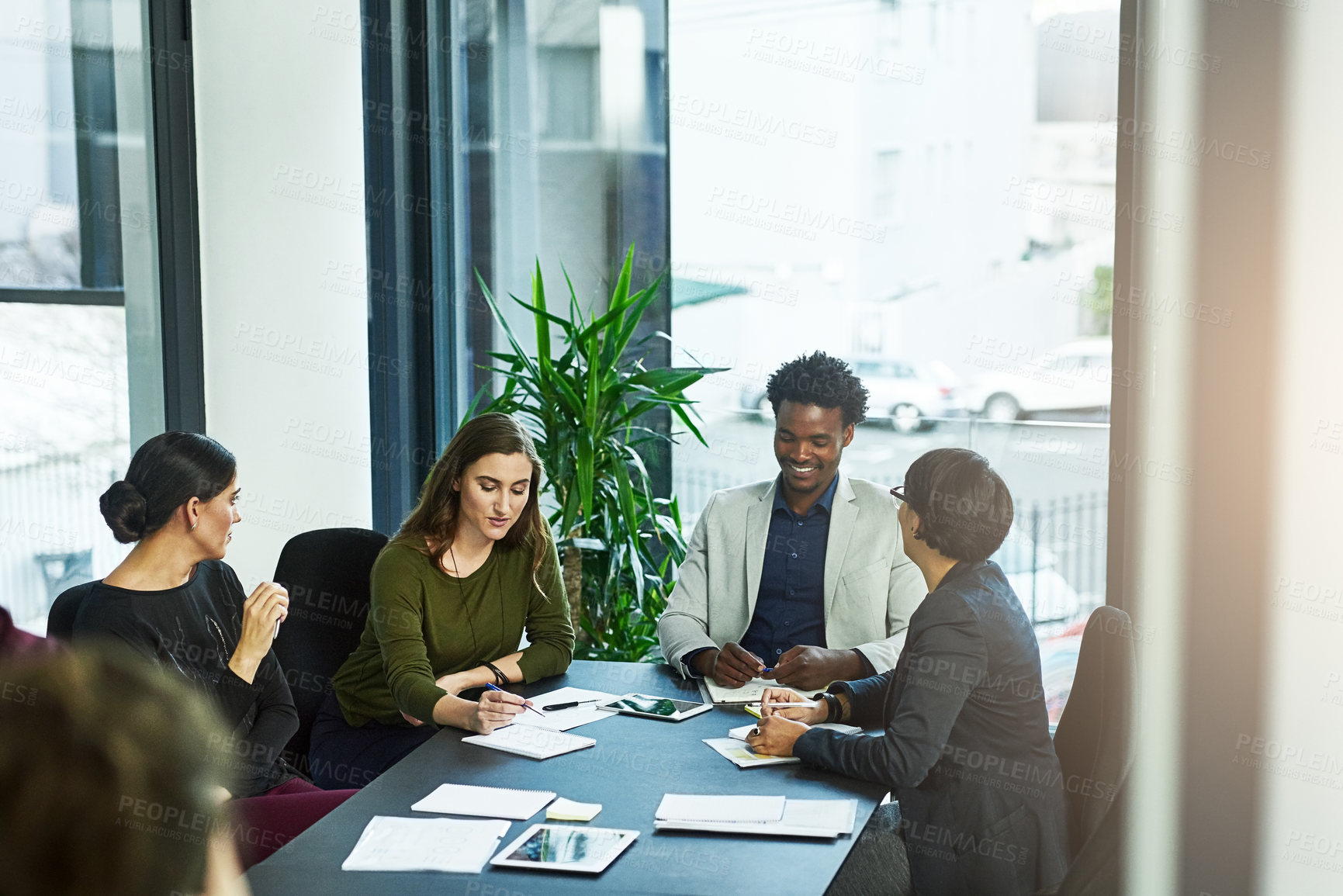 Buy stock photo Shot of a group of businesspeople having a meeting in the boardroom