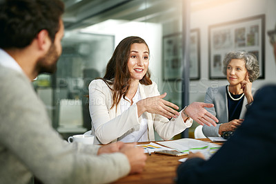 Buy stock photo Cropped shot of a group of businesspeople meeting in the boardroom