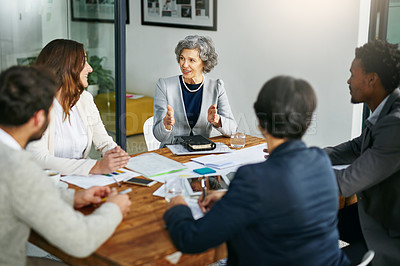 Buy stock photo Business people, talking or mature woman in meeting for planning, collaboration or teamwork at office. Group, female mentor or investors with strategy for discussion, conversation or feedback review