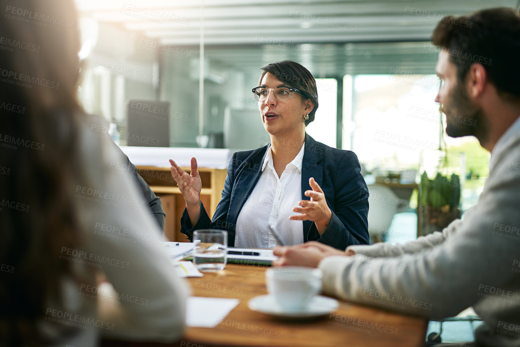 Buy stock photo Cropped shot of a group of businesspeople meeting in the boardroom