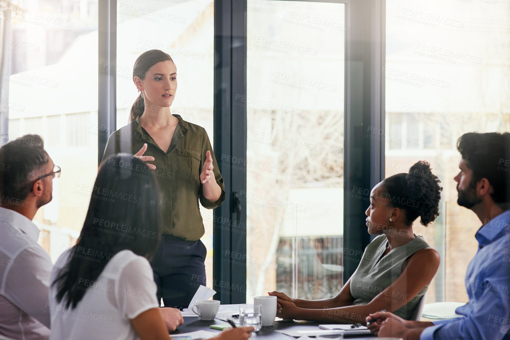 Buy stock photo Cropped shot of a group of diverse businesspeople having a meeting in the boardroom