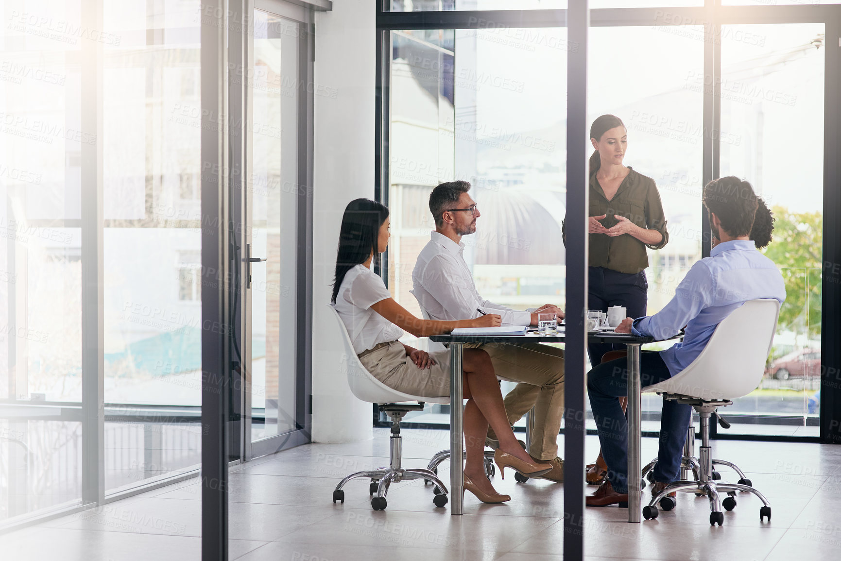 Buy stock photo Full length shot of a group of diverse businesspeople having a meeting in the boardroom