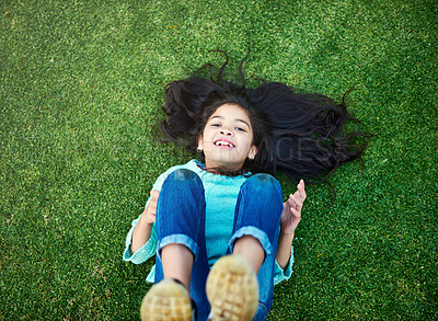 Buy stock photo Portrait, child and grass with smile for resting in park with happy on weekend in nature or garden. Girl, development and green in summer with backyard or vacation in childhood with freedom.