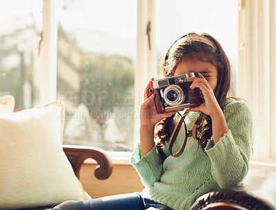 Buy stock photo Home, girl and child with vintage camera, photography and memory with fun, playful and relax in living room. Apartment, retro or kid taking picture, creative and hobby with lens, learning or creative