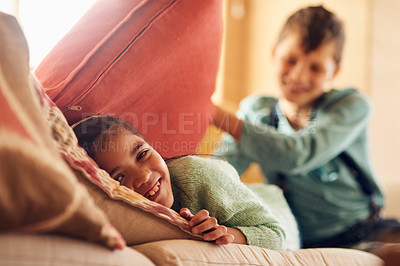 Buy stock photo Family, game of hide and seek with children playing together in living room of home for bonding. Development, kids or love with sibling brother and sister pillow fight game on sofa in apartment