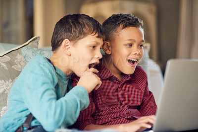 Buy stock photo Shot of two young boys looking astonished by something on the internet