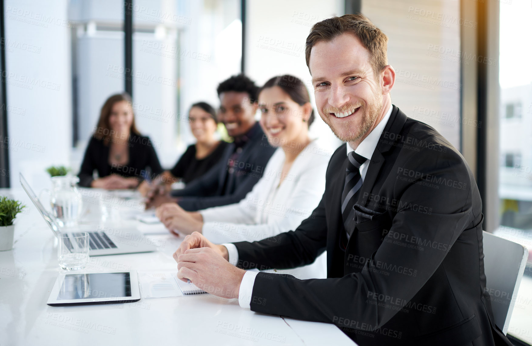 Buy stock photo Meeting, portrait and happy man with business people in conference room with confidence, tech or plan. Boardroom, men and women in corporate workshop with laptop, report and smile at startup office