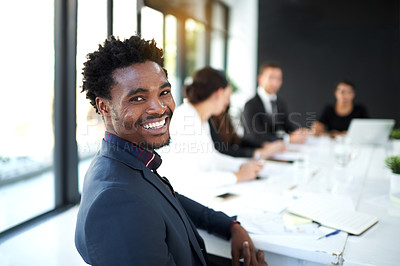 Buy stock photo Portrait of a businessman sitting in a boardroom meeting with colleagues in the background