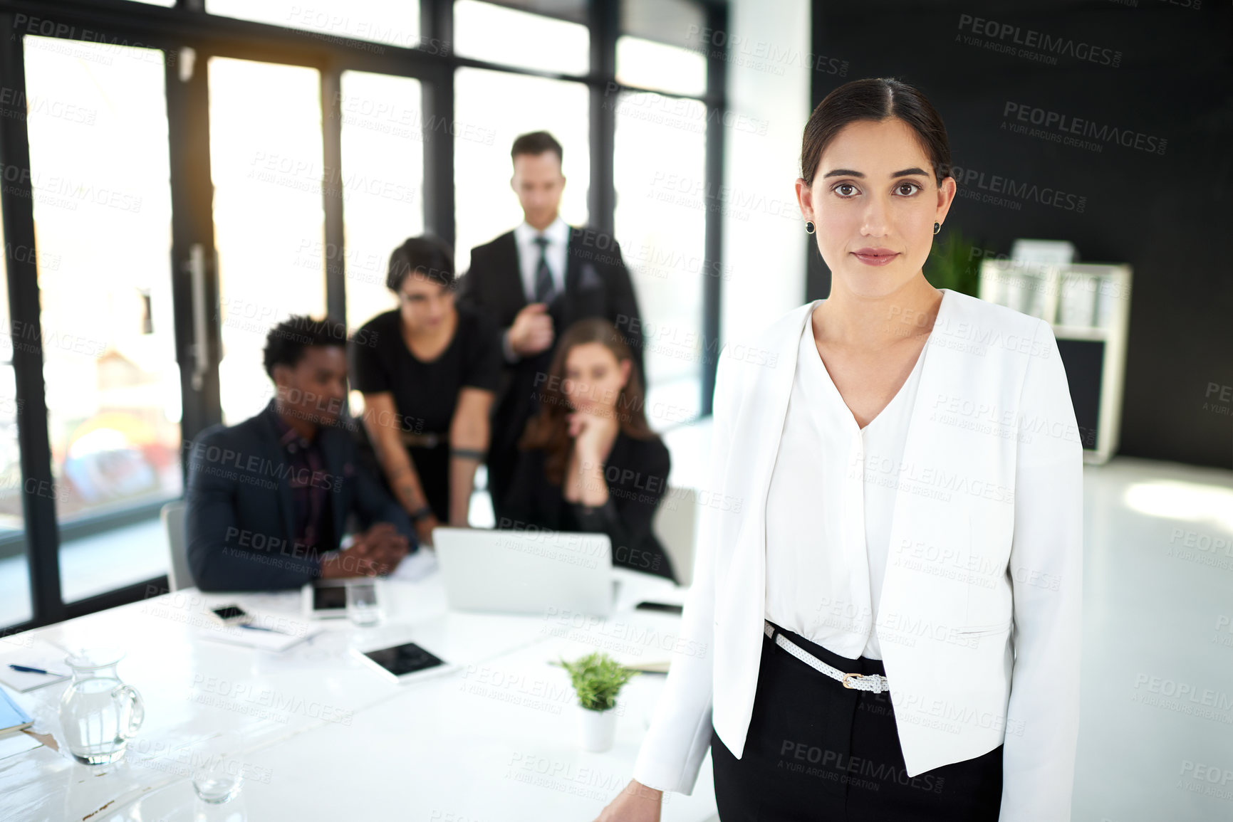 Buy stock photo Corporate, portrait of businesswoman in office with confidence for leader or manager and team in meeting. Pride, smile and woman with business people, collaboration and work on startup project