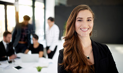 Buy stock photo Portrait of a businesswoman standing in a boardroom meeting with colleagues in the background