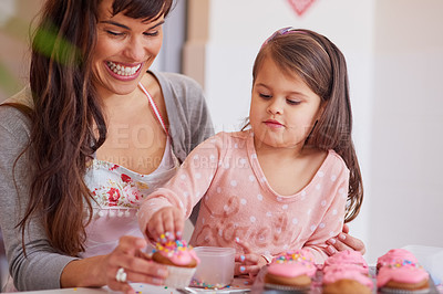 Buy stock photo Cropped shot of a little girl baking together with her mother at home