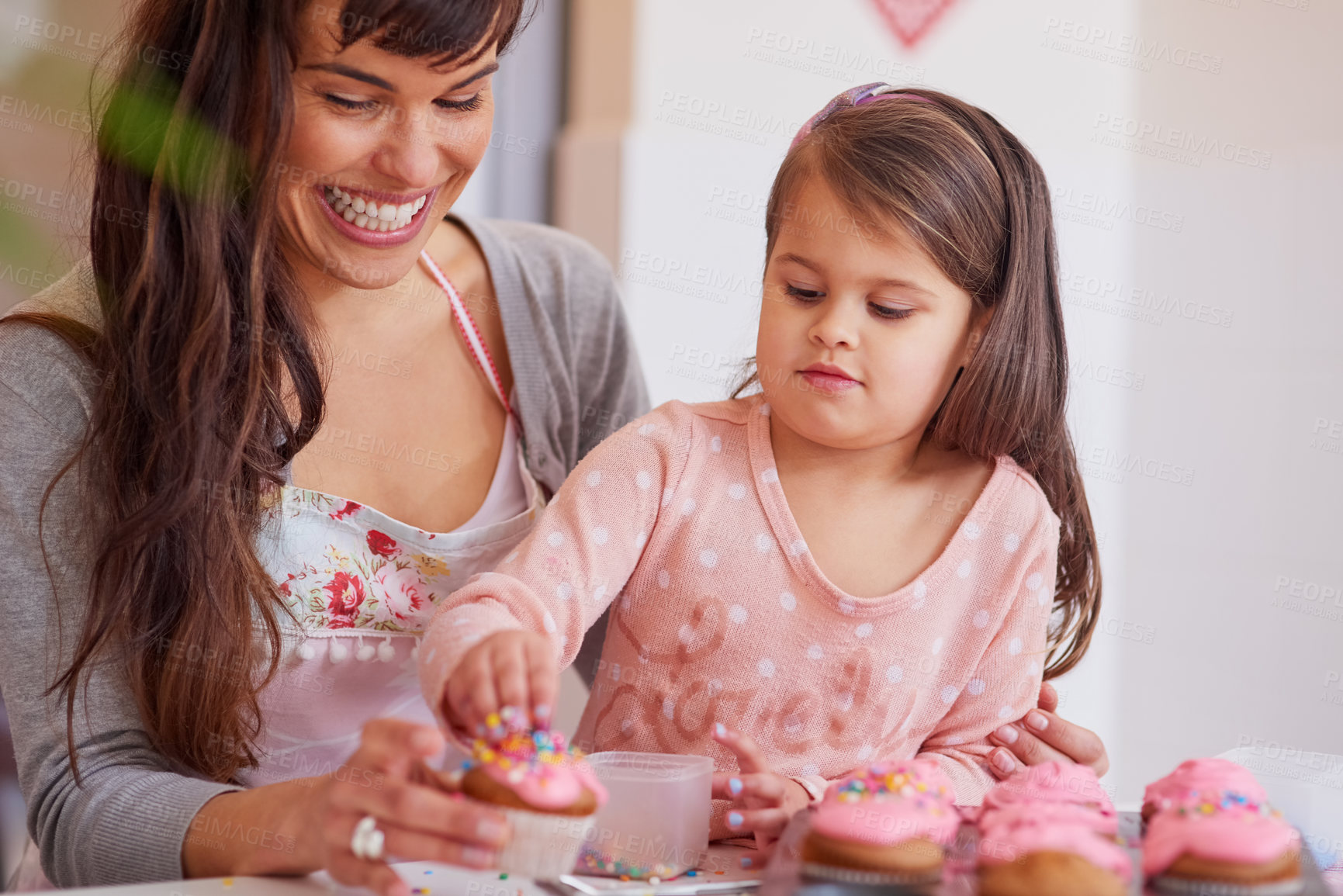 Buy stock photo Cropped shot of a little girl baking together with her mother at home