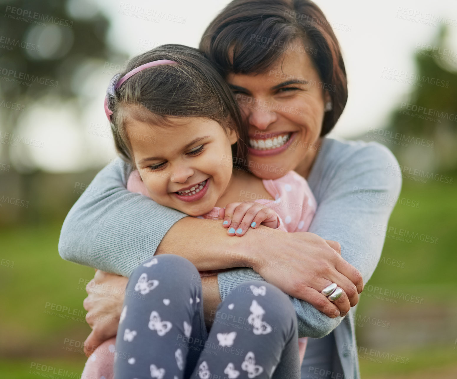 Buy stock photo Outdoor, backyard and portrait of mom in hug with girl on holiday, vacation or relax together in summer. Happy, mother and child with support of family and playing with fun in playground or park