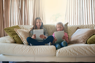 Buy stock photo Girl, children and tablet on couch for online streaming, social media and happy together on holiday in home. Family, sister and technology on sofa for internet, gaming and smile for cartoon in lounge