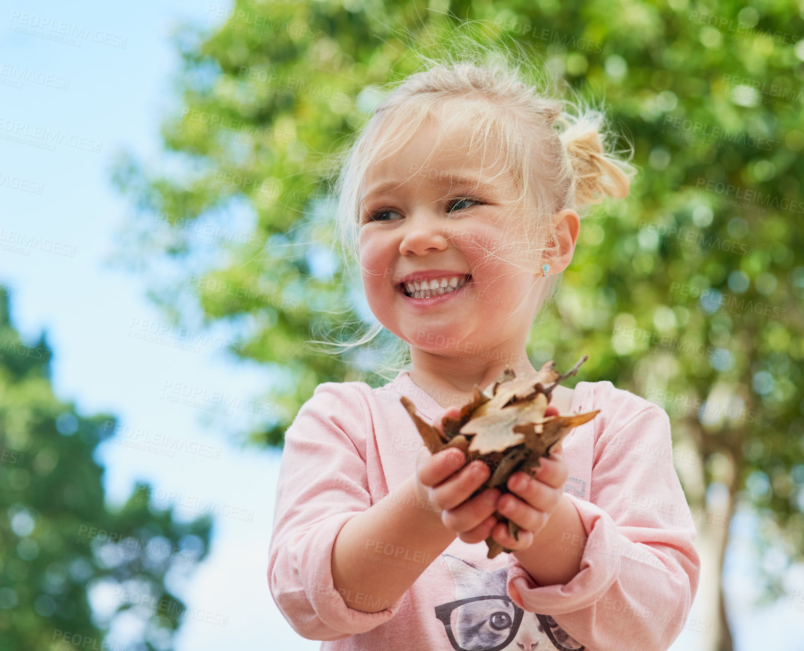 Buy stock photo Girl, leaves and play outdoors for fun, learning nature and child development in park playground. Female person, kid and happy or outside curious, plants and countryside discovery or explore trees