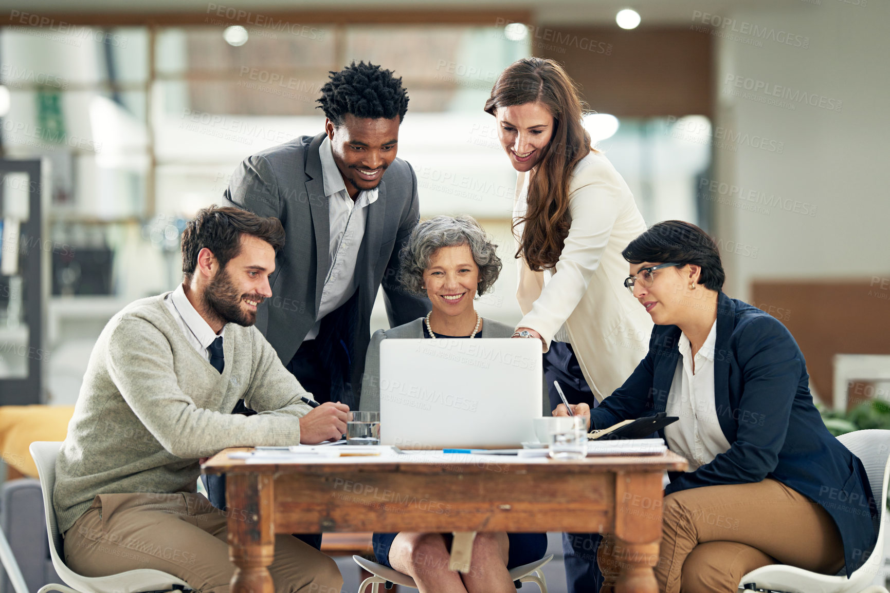 Buy stock photo Cropped shot of a group of businesspeople meeting in the boardroom