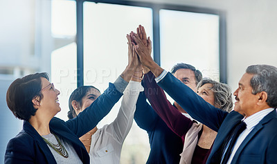 Buy stock photo Cropped shot of a group of happy businesspeople giving each other a high five in the office