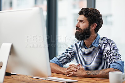 Buy stock photo Cropped shot of a young creative working on a computer in an office