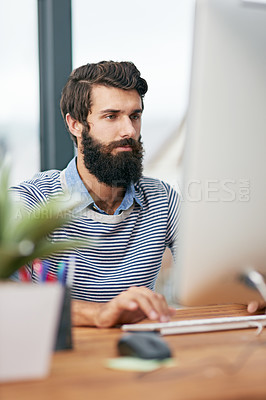 Buy stock photo Cropped shot of a young creative working on a computer in an office