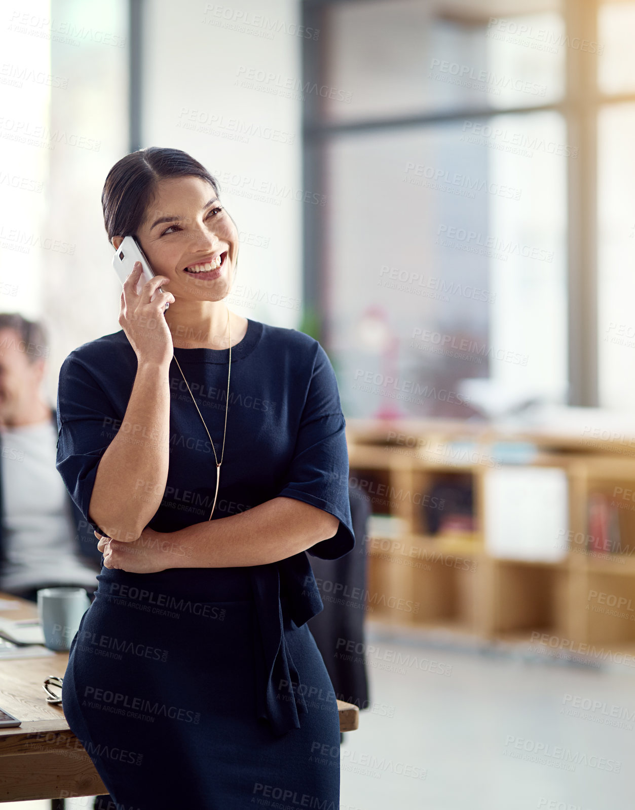 Buy stock photo Cropped shot of a young businesswoman talking on a cellphone in a modern office