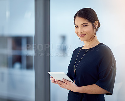 Buy stock photo Cropped portrait of a smiling businesswoman using her tablet in the office