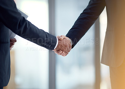 Buy stock photo Cropped shot of two businessmen shaking hands