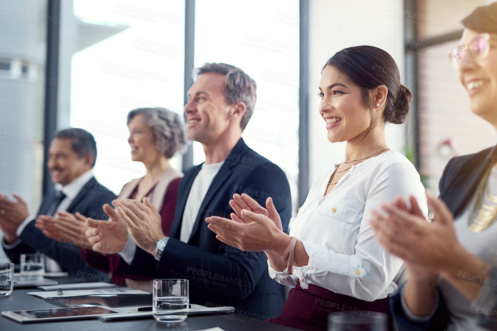Buy stock photo Shot of a group of businesspeople sitting in a conference