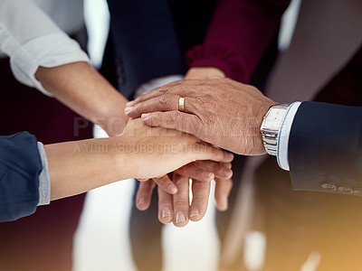 Buy stock photo Cropped shot of a diverse team of colleagues joining their hands together in unity
