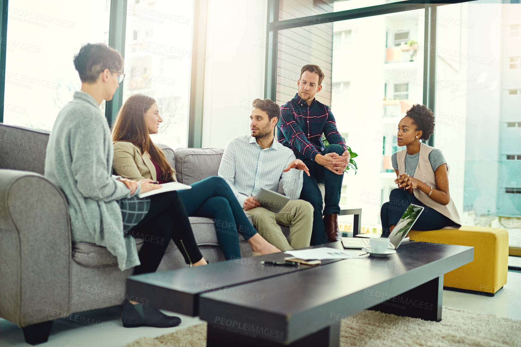 Buy stock photo Teamwork, tablet and employee talking on sofa for communication, collaboration and conversation in office. Planning, ideas and employees with laptop or technology for startup project with discussion