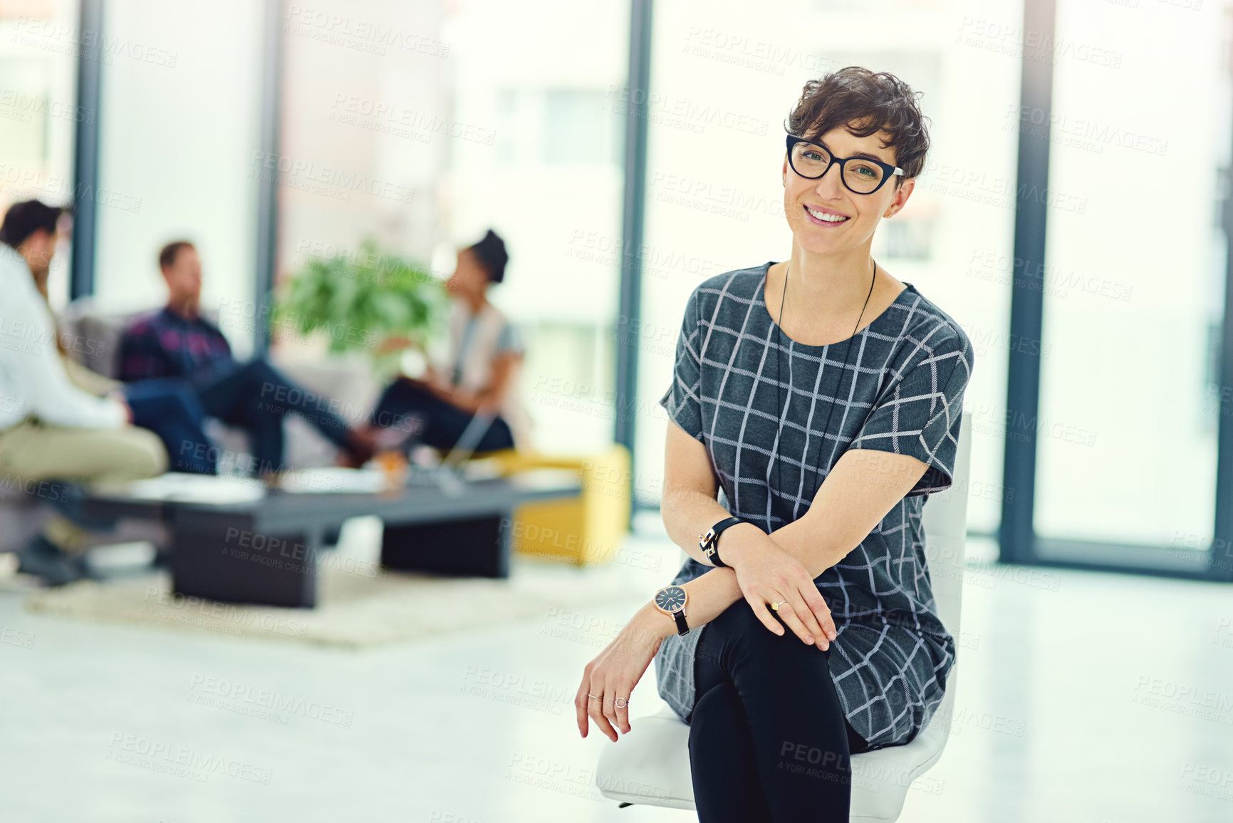 Buy stock photo Portrait, woman and sitting with confidence in modern office for startup company, collaboration and design. Female entrepreneur, pride and smile for small business with creative job and team