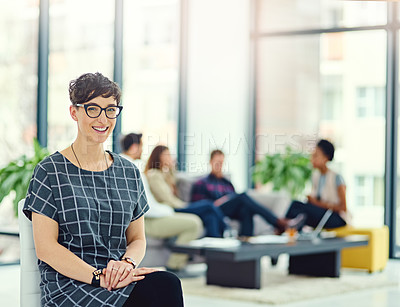 Buy stock photo Portrait of a confident young creative sitting in an office with colleagues in the background