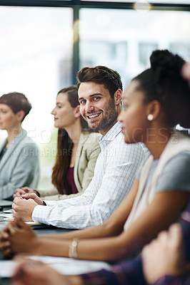 Buy stock photo Portrait of a businessman sitting with his colleagues in a boardroom meeting