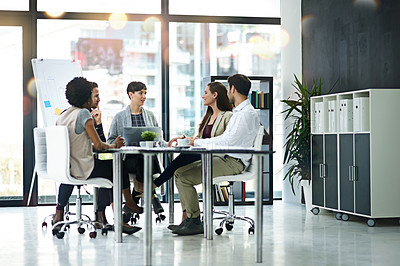 Buy stock photo Shot of a group of businesspeople having a meeting together in a modern office