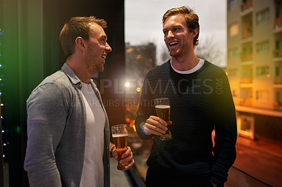 Buy stock photo Cropped shot of guys talking while drinking beer at a party